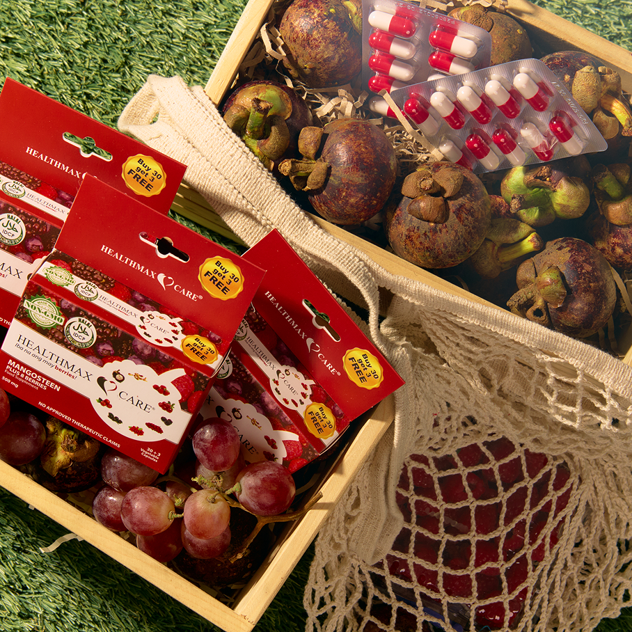 Healthmax Care Mangosteen Plus 8 Berries supplement boxes with mangosteen fruits, grapes, and capsule blister packs