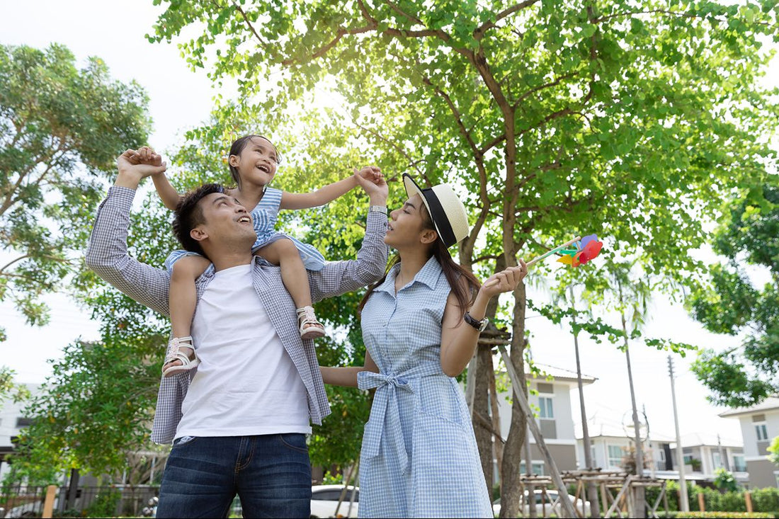 Family enjoying an outdoor summer day together under the trees