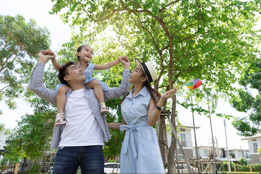 Family enjoying an outdoor summer day together under the trees