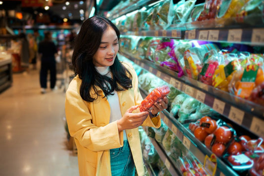 Woman shopping for fresh vegetables in a grocery store for a healthier summer diet