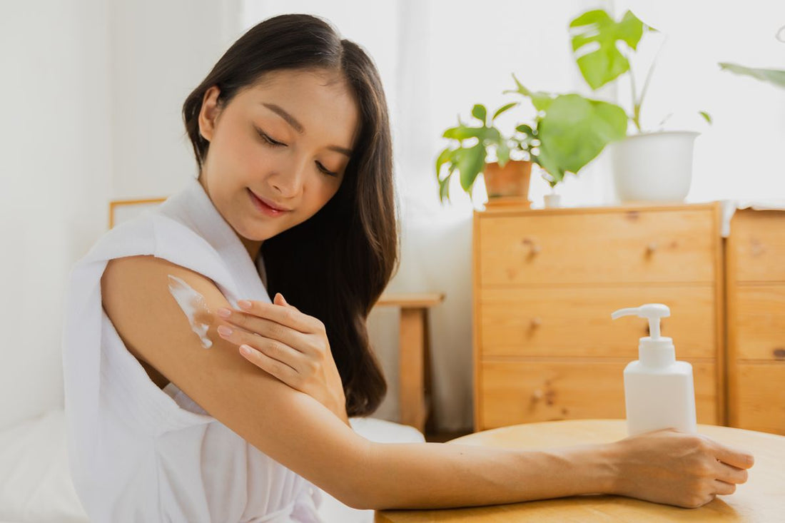 Woman applying soothing lotion to her upper arm as part of a muscle care routine